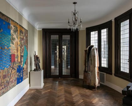 El pasillo distribuidor de habitaciones está repleto de obras de arte