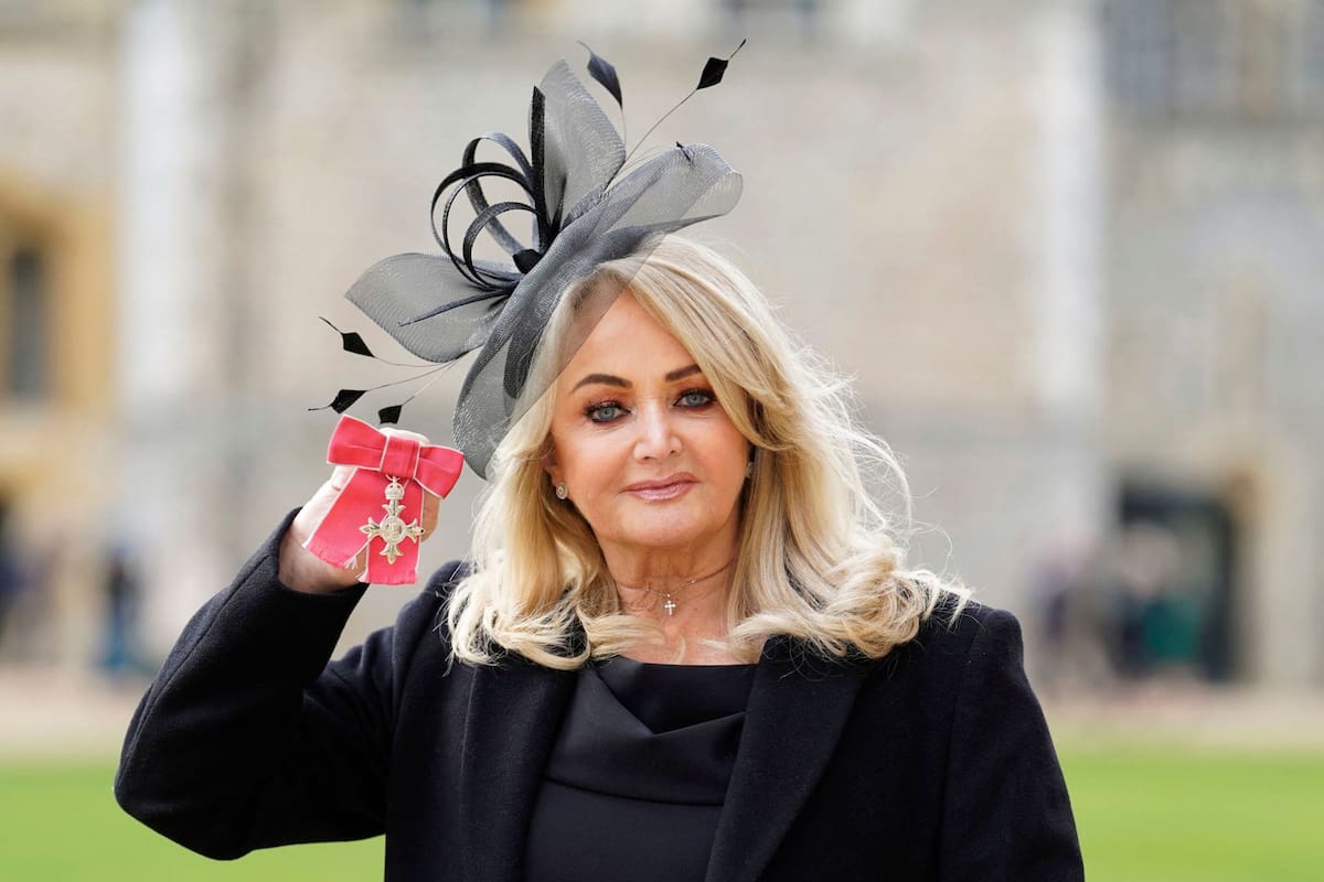 (FILES) British singer Gaynor Sullivan aka Bonnie Tyler poses with her medal after being appointed a Member of the Order of the British Empire (MBE) during an investiture ceremony at Windsor Castle in Windsor, west of London, on February 1, 2023. Welsh singer Bonnie Tyler best known for her powerful, haunting love song "Total Eclipse of the Heart" has died at the age of 75, her family announced on July 9, 2026. (Photo by Andrew Matthews / POOL / AFP)